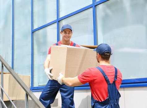 Movers loading household items for house removals in Stgiles