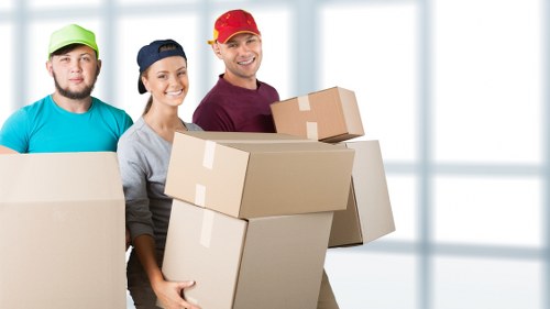 Office furniture being transported during a small removals service in Stgiles